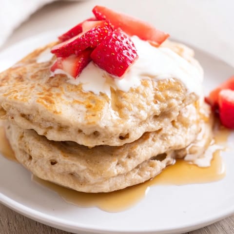 A stack of warm Protein Banana Pancakes, inviting you to enjoy a flavorful breakfast.