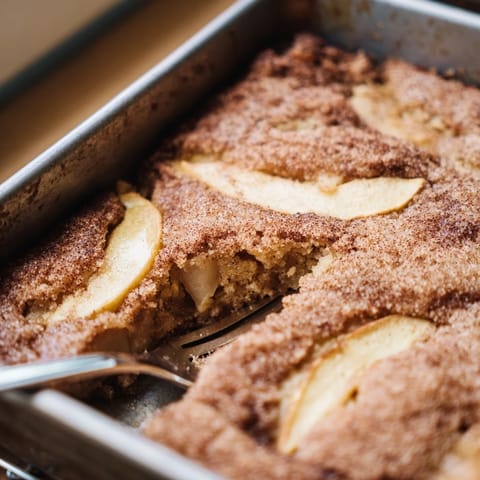 Sliced Baked Apple Cake showing tender apples baked into a soft, golden Dutch-inspired dessert, perfect with a cup of coffee.