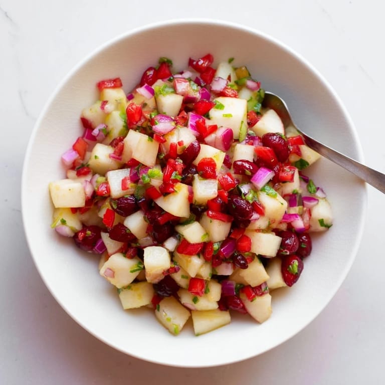 Fresh pear and cranberry jalapeño salsa, bursting with flavors for your next party.