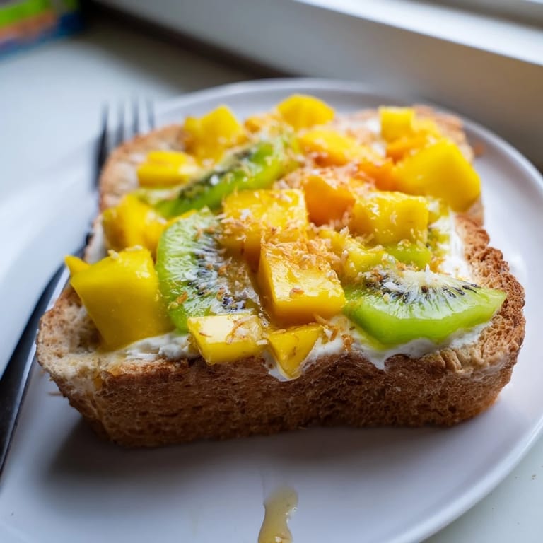 Bright and flavorful yogurt-custard toast, bursting with fresh fruit and coconut sprinkles.