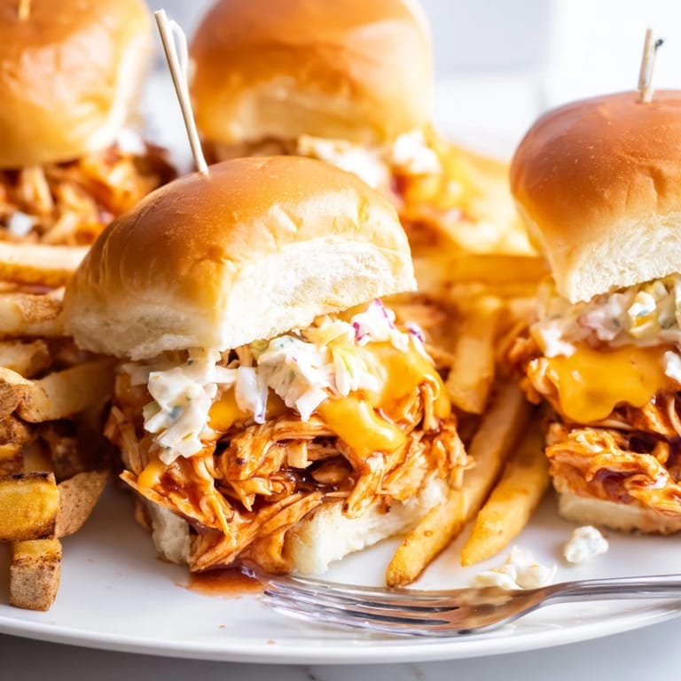 Tender shredded BBQ chicken on mini slider buns, paired with golden crispy fries.  