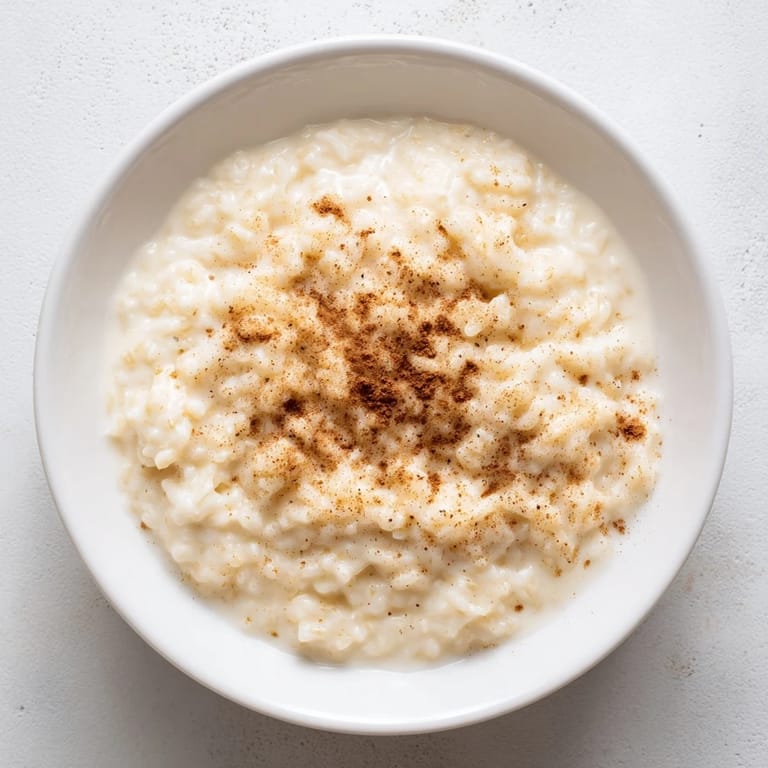 Enjoy a bowl of rice pudding made with leftover rice, garnished beautifully with cinnamon.