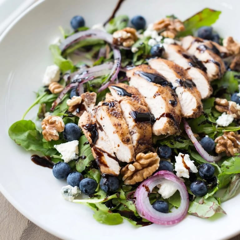 This photo features perfectly grilled chicken and fresh blueberries in a colorful Goat Cheese Chicken Salad.