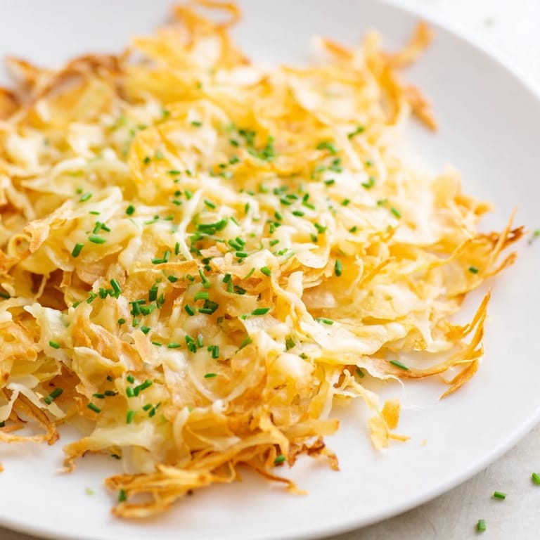 Close-up of crispy, savory Crispy Onion Cheese Chips, showing layers of onion and bubbling, golden cheese.