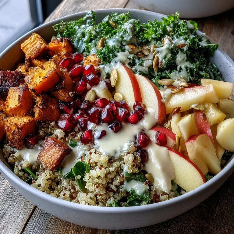 Bright pomegranate seeds and crunchy pepitas top a hearty Kale Harvest Grain Bowl, drizzled with tangy maple Dijon dressing.