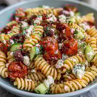 Easy Picnic Pasta Salad with Italian Dressing, bursting with colorful vegetables and mozzarella, served chilled for a refreshing summer side dish.  